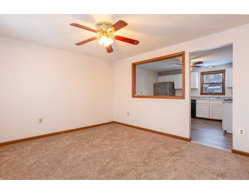 152 Starling Road Springfield, MA 01119 - Photo 10 of 28 a view of a livingroom with a ceiling fan and a window