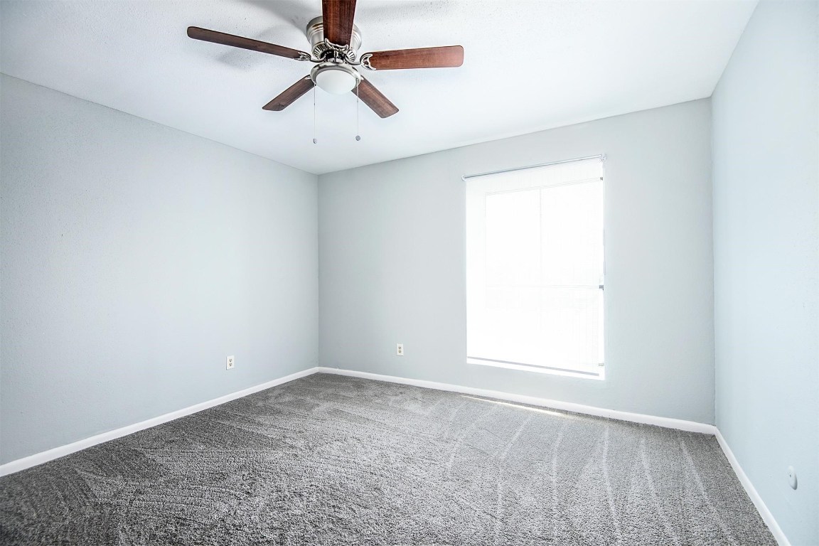 3085 Walnut Bend Lane, Unit 35 Houston, TX 77042 - Photo 13 of 23 an empty room with a window and a fan