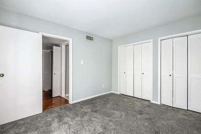 a view of an empty room and closet area