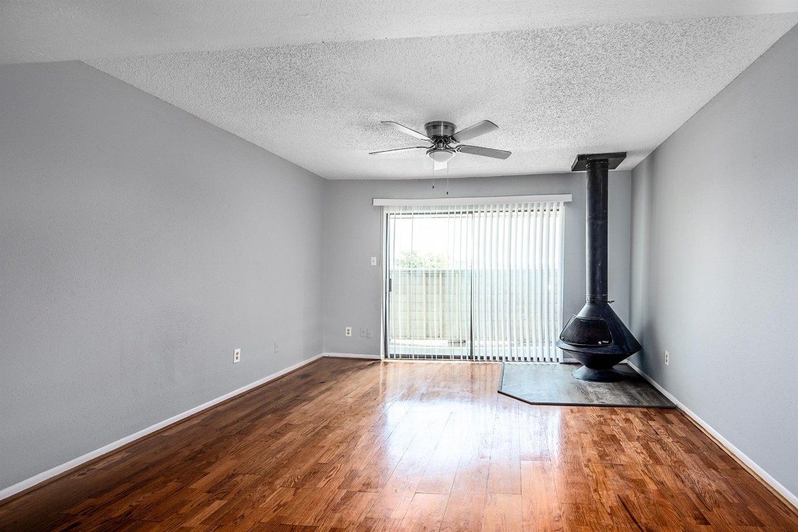 3085 Walnut Bend Lane, Unit 35 Houston, TX 77042 - Photo 3 of 23 a view of an empty room with window and wooden floor