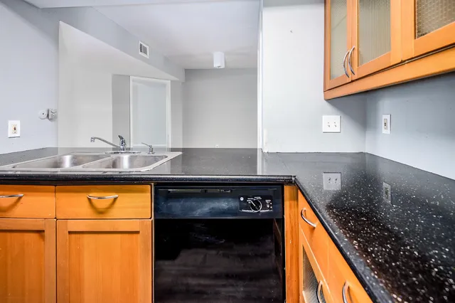 a kitchen with granite countertop cabinets and stove top oven