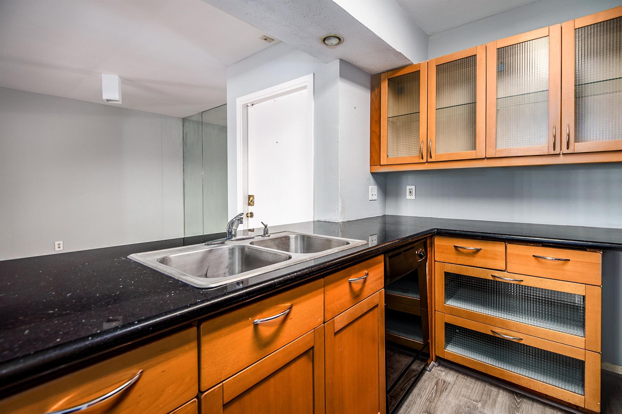 3085 Walnut Bend Lane, Unit 35 Houston, TX 77042 - Photo 6 of 23 a kitchen with granite countertop sink and cabinets