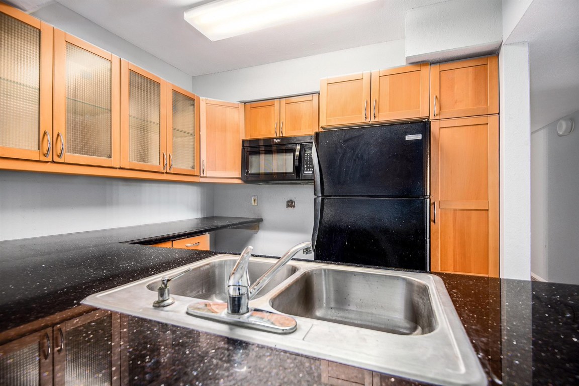 3085 Walnut Bend Lane, Unit 35 Houston, TX 77042 - Photo 8 of 23 a kitchen with a sink a refrigerator and a window