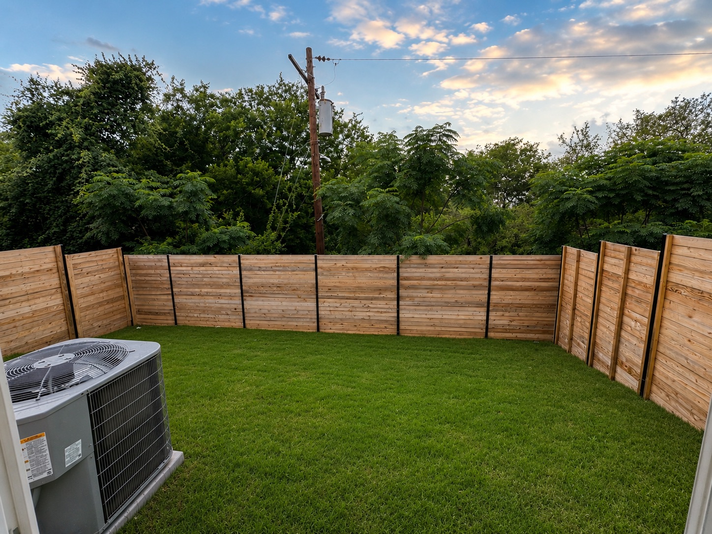 2000 Riverside Farms Road, Unit 6102 Austin, TX 78741 - Photo 10 of 11 A verdant lawn is framed by new wood fencing, creating a private outdoor retreat.