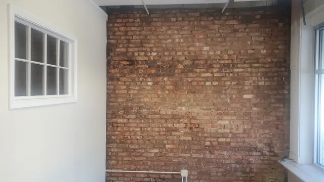 a hallway with a view of living room with wooden floor