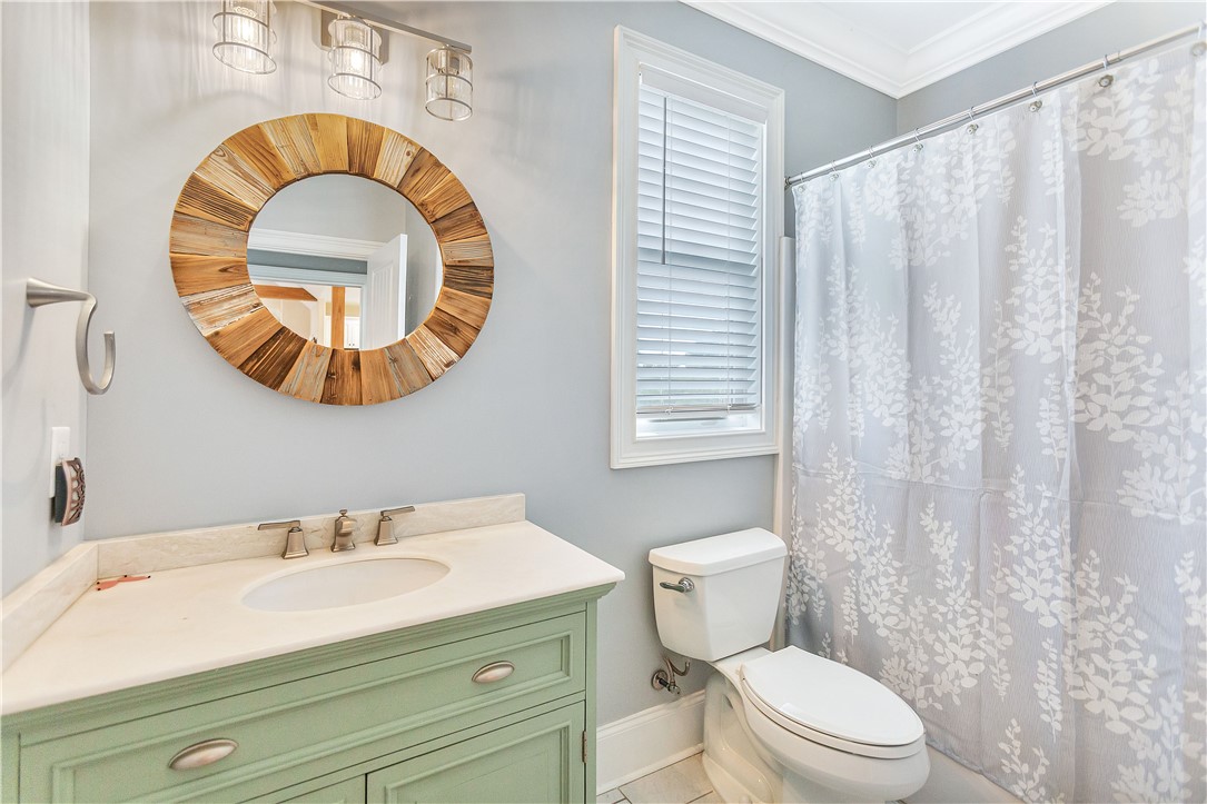 1204 Cherokee Road Townville, SC 29689 - Photo 27 of 44 A well-appointed bathroom features a light green vanity and a unique wood-framed mirror.