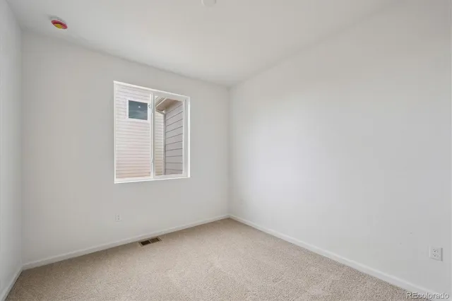 a view of an empty room and closet area