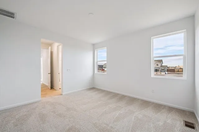 a bathroom with a double vanity sink mirror and toilet