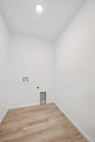 a view of a kitchen with kitchen island a sink wooden floor and a large window