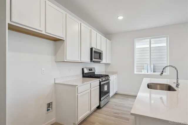 a view of kitchen and sink with wooden floor