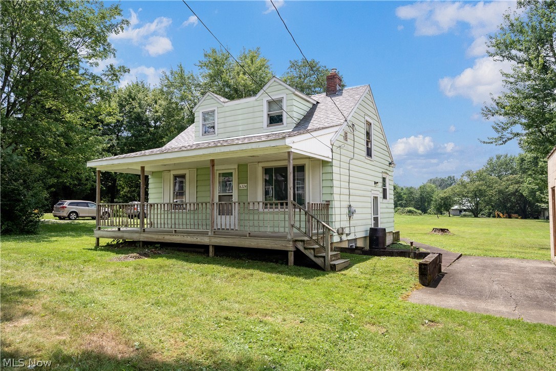 6324 Struthers Road Youngstown, OH 44514 - Photo 5 of 42 Light green siding exterior featuring a covered porch with wood railings and steps