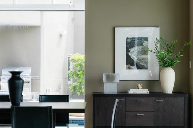 a living room with lots of furniture and a floor to ceiling window