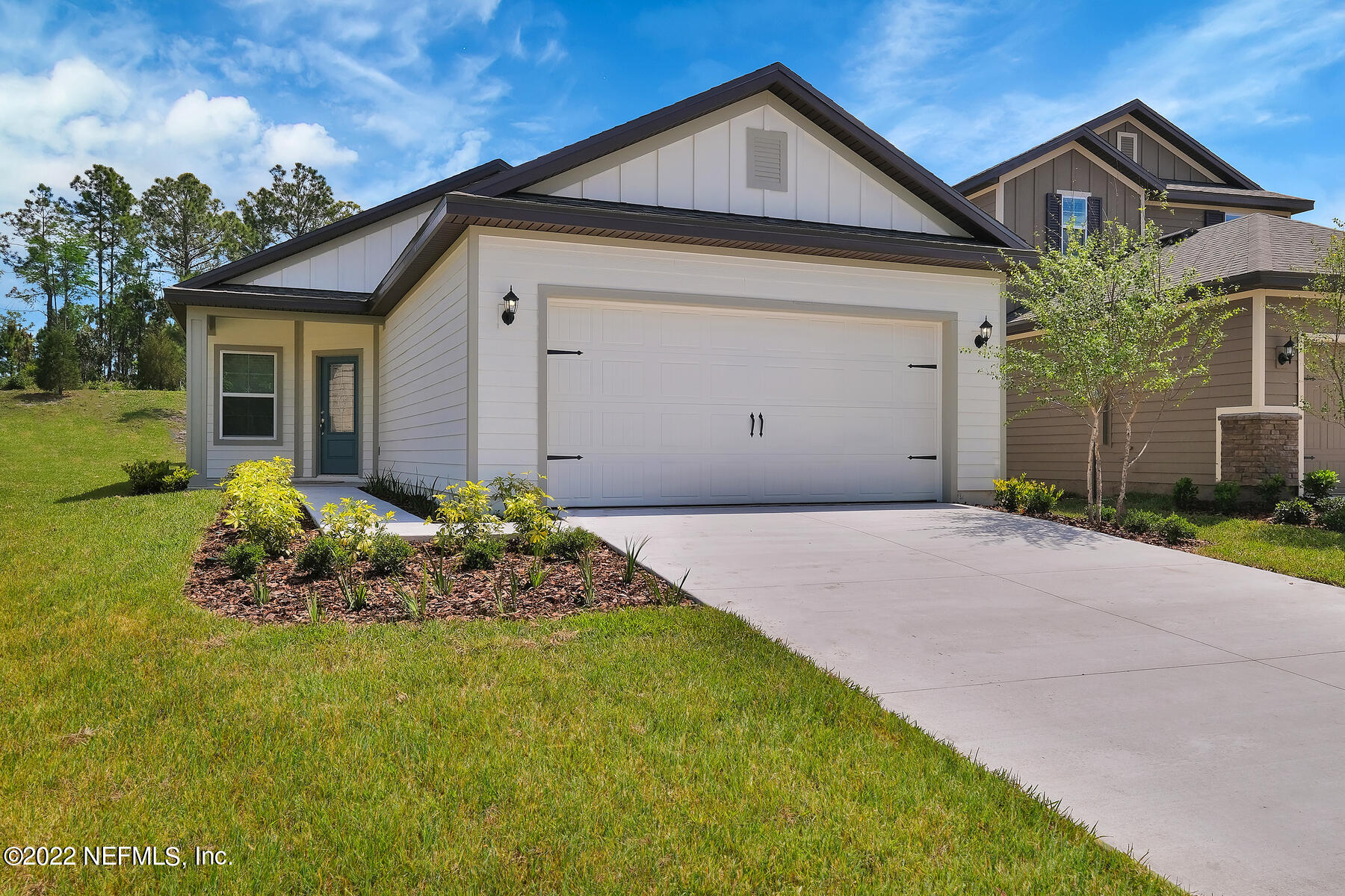 437 Falcon Ridge Road St. Augustine, FL 32084 - Photo 1 of 13 a front view of a house with a yard and garage