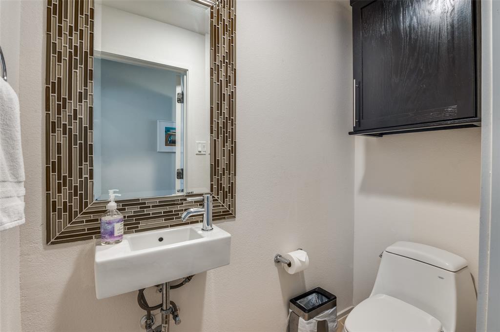 2012 Matilda Street Dallas, TX 75206 - Photo 12 of 24 a bathroom with a sink a toilet and mirror