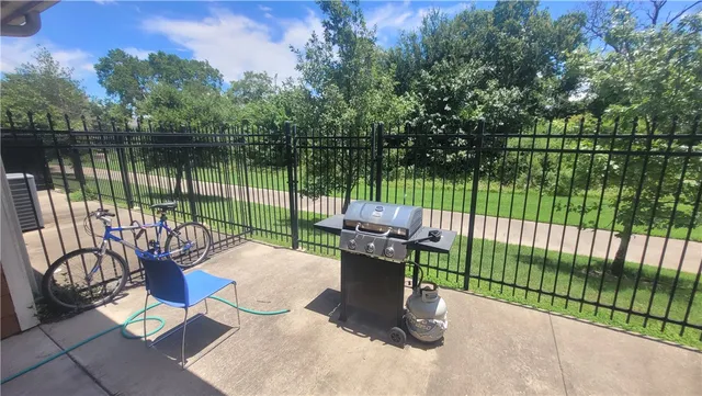 a view of a patio with a table chairs and a garden