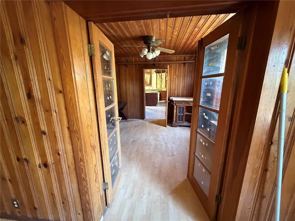 9602 North Taylor Road Seffner, FL 33584 - Photo 13 of 24 a view of a hallway with wooden floor and staircase