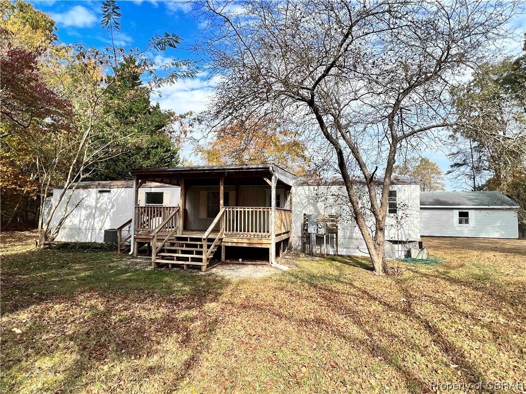 Rear view of house with a yard