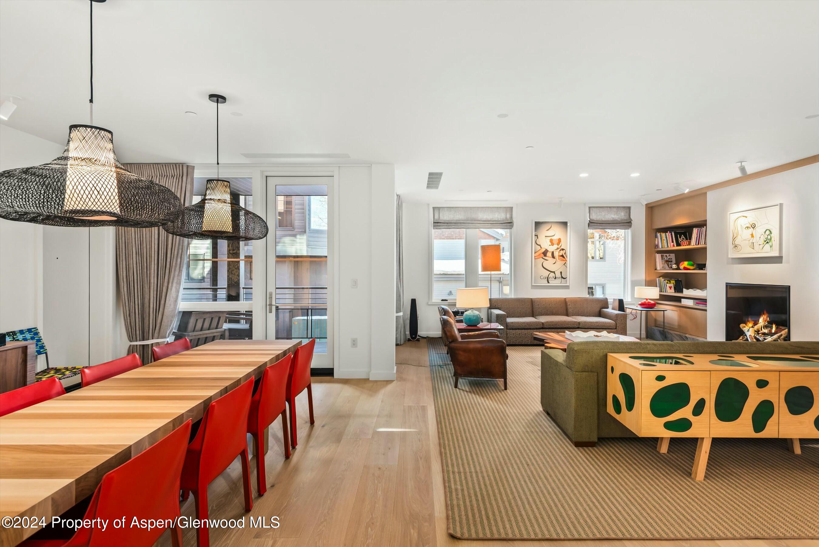 233 East Cooper Avenue, Unit 207 Aspen, CO 81611 - Photo 11 of 45 a living room with furniture a rug and a fireplace