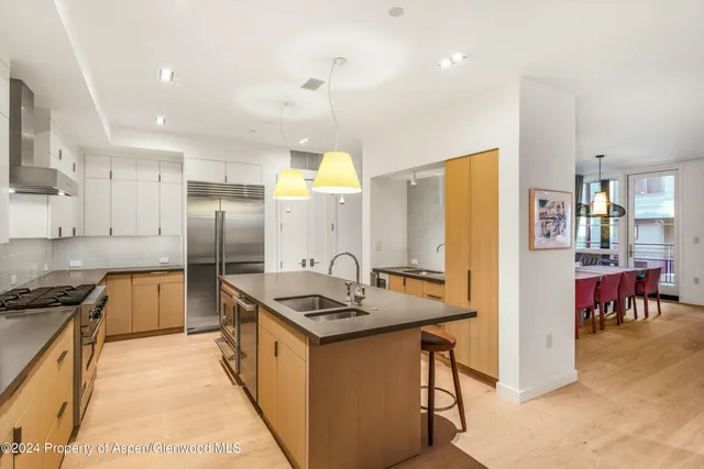a kitchen with stainless steel appliances a sink a stove and a refrigerator