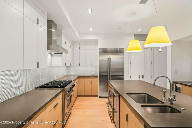 a kitchen with stainless steel appliances granite countertop a sink counter space and cabinets