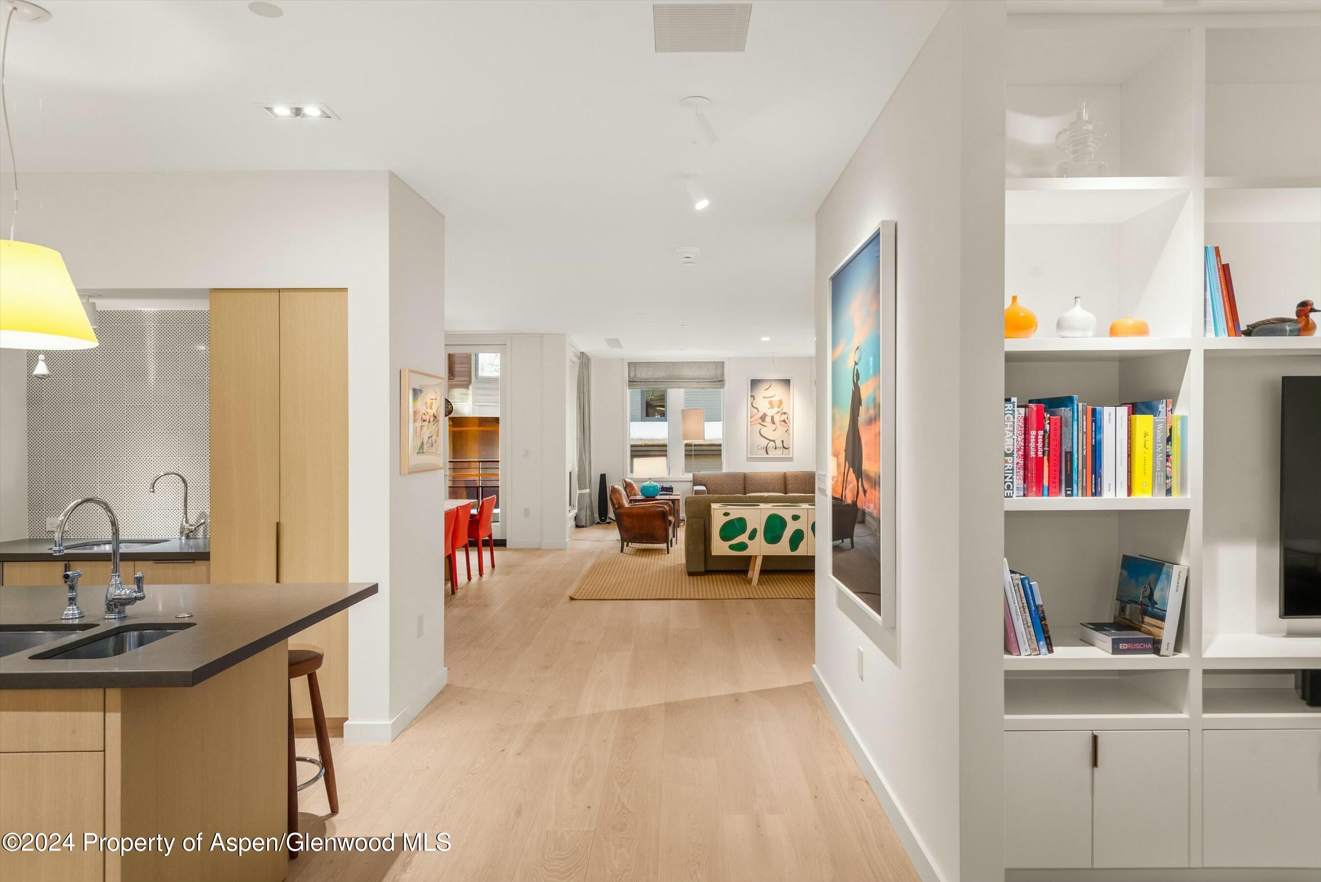 233 East Cooper Avenue, Unit 207 Aspen, CO 81611 - Photo 15 of 45 a living room with furniture and a book shelf