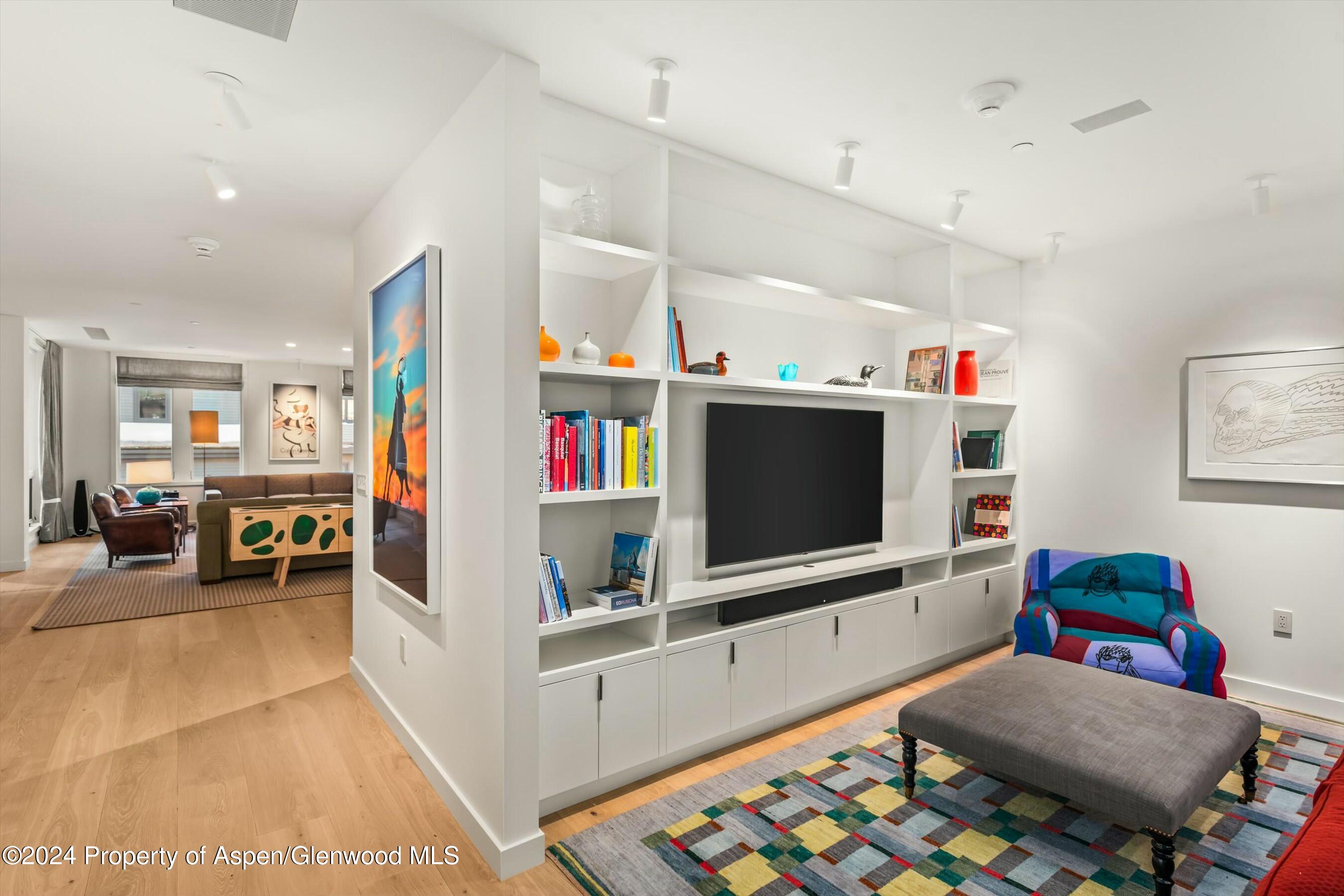 233 East Cooper Avenue, Unit 207 Aspen, CO 81611 - Photo 16 of 45 a living room with furniture and a flat screen tv