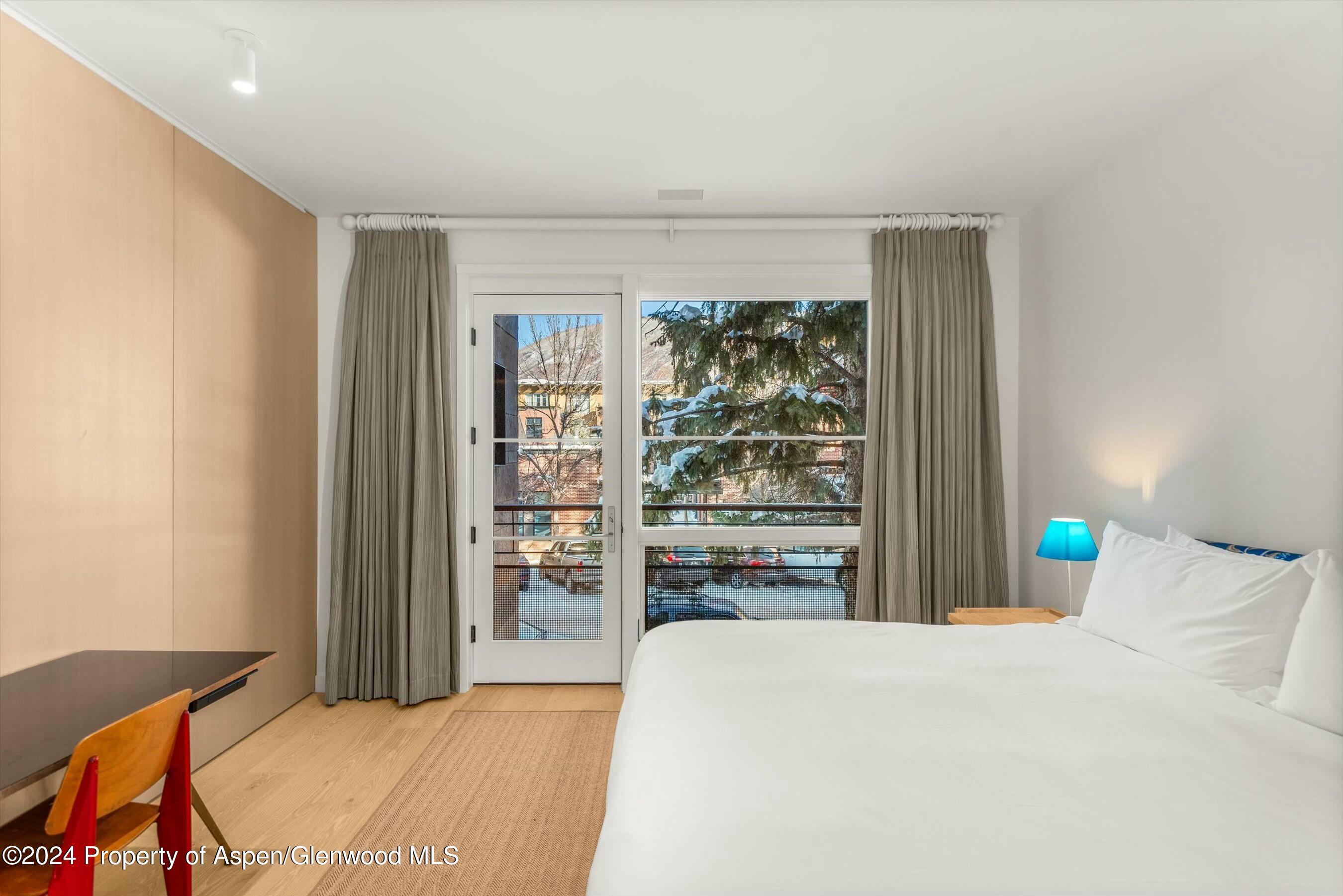 233 East Cooper Avenue, Unit 207 Aspen, CO 81611 - Photo 19 of 45 a bedroom with a bed and a window