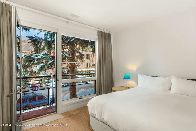 a bathroom with a granite countertop sink a large mirror and a shower