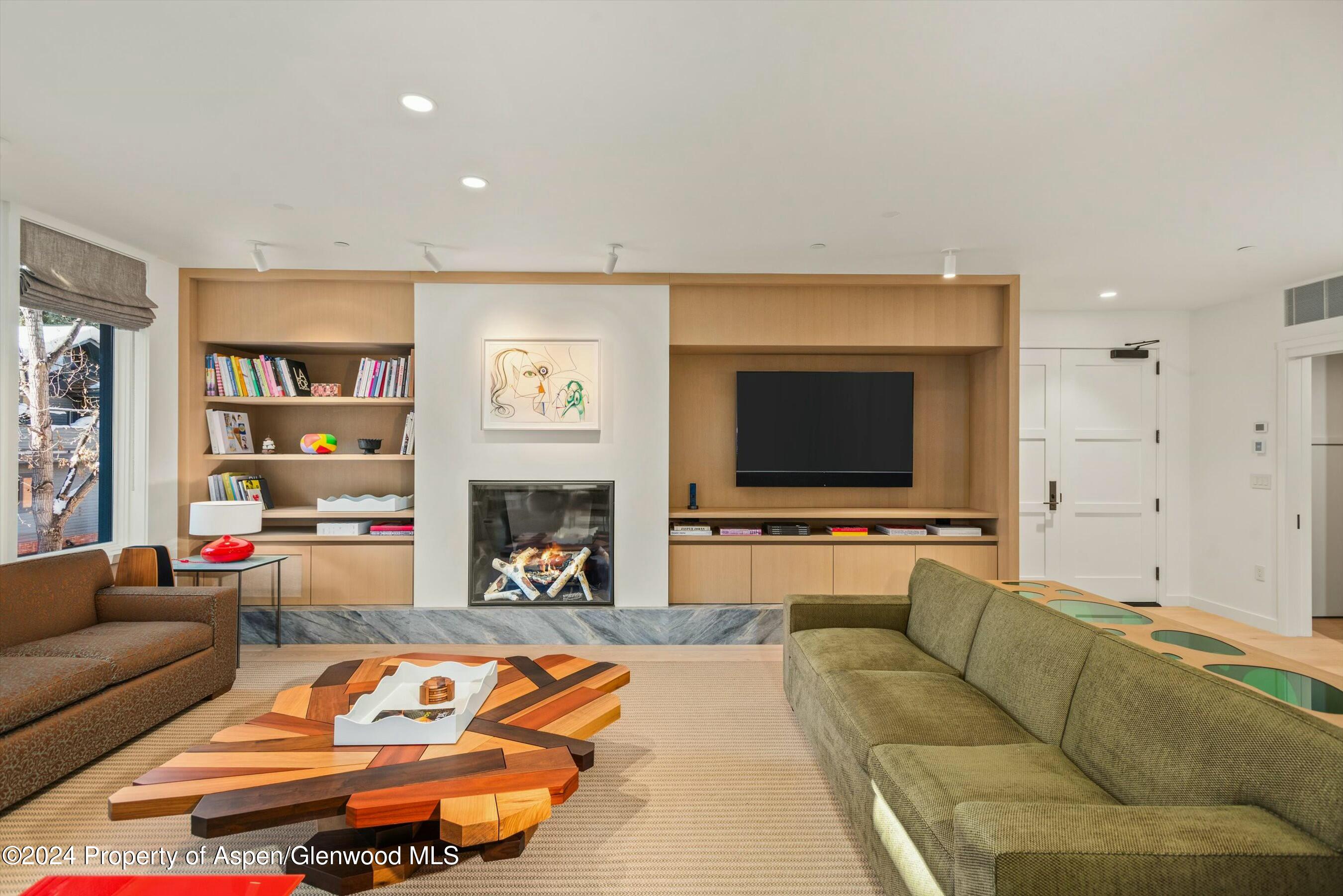 233 East Cooper Avenue, Unit 207 Aspen, CO 81611 - Photo 2 of 45 a living room with furniture and a flat screen tv