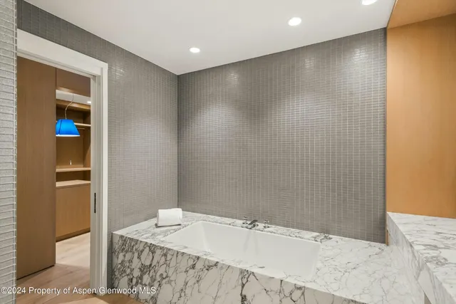 a bathroom with a granite countertop sink a toilet and shower
