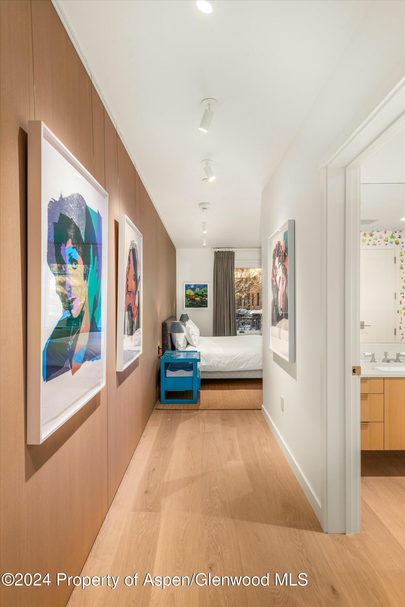 233 East Cooper Avenue, Unit 207 Aspen, CO 81611 - Photo 26 of 45 a bedroom with furniture and a painting on the wall