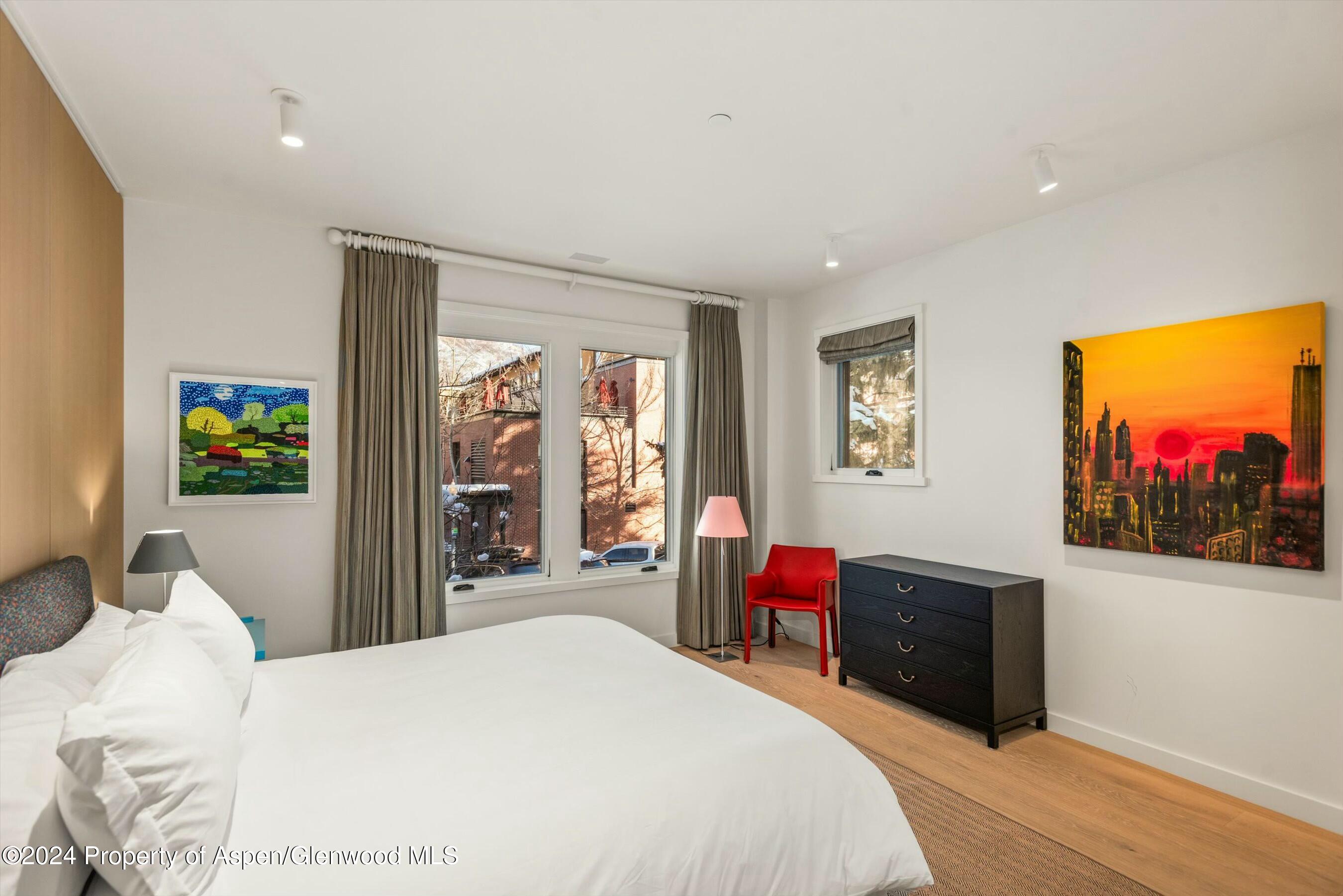 233 East Cooper Avenue, Unit 207 Aspen, CO 81611 - Photo 27 of 45 a bedroom with a bed and a flat screen tv