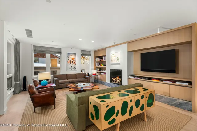 a living room with fireplace furniture and a flat screen tv