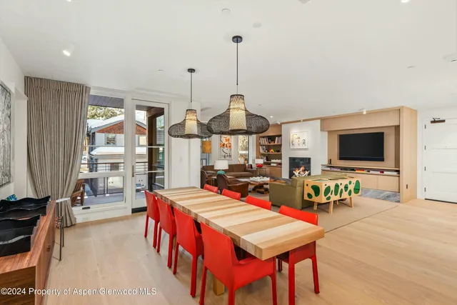 a living room with furniture a flat screen tv and a large window
