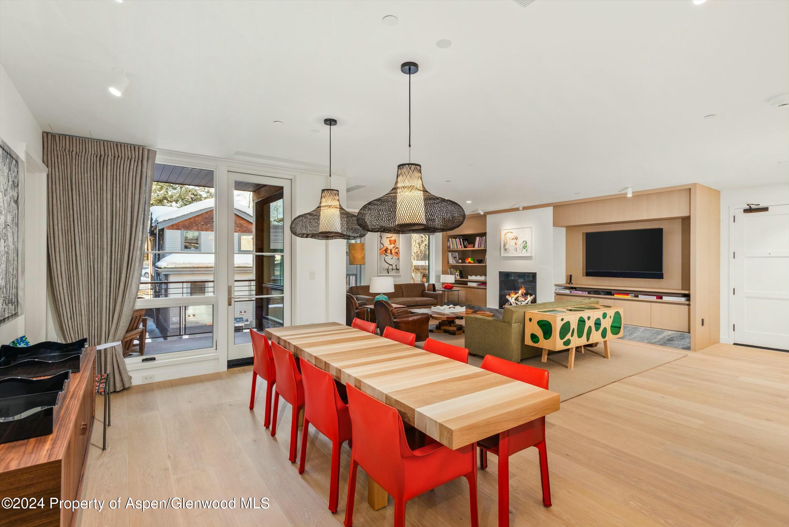 233 East Cooper Avenue, Unit 207 Aspen, CO 81611 - Photo 9 of 45 a living room with furniture a flat screen tv and a large window