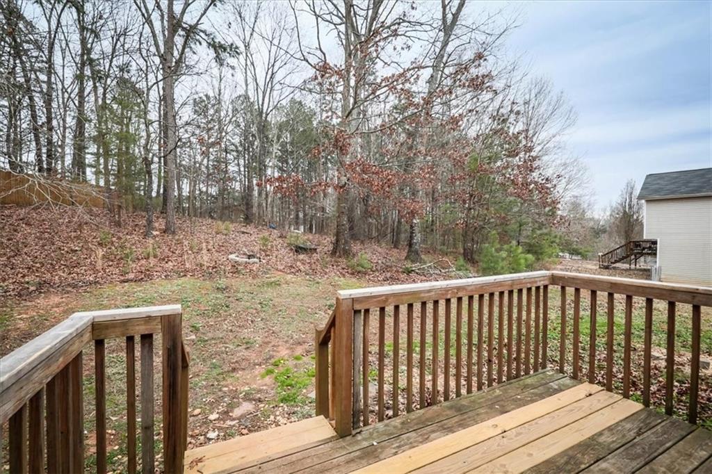 385 Prometheous Way Rockmart, GA 30153 - Photo 24 of 27 a view of backyard with wooden fence and large trees
