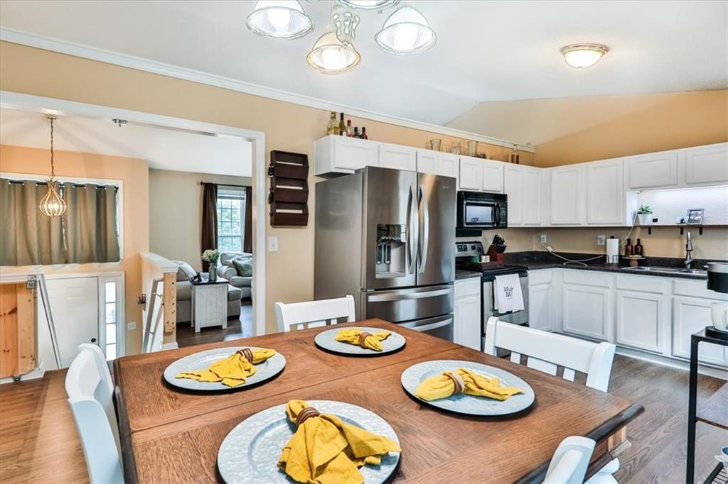385 Prometheous Way Rockmart, GA 30153 - Photo 9 of 27 a kitchen with stainless steel appliances granite countertop a dining table and chairs