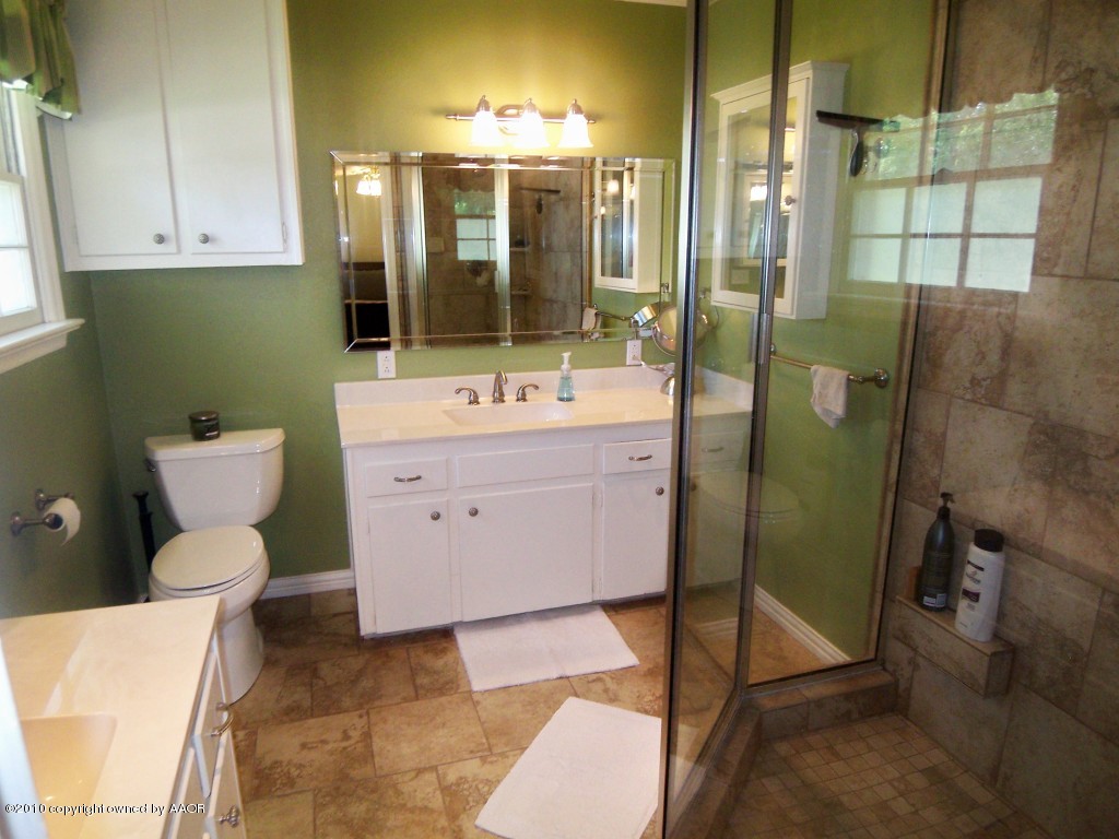 6301 Elmhurst Road Amarillo, TX 79106 - Photo 11 of 20 a bathroom with a sink toilet and shower