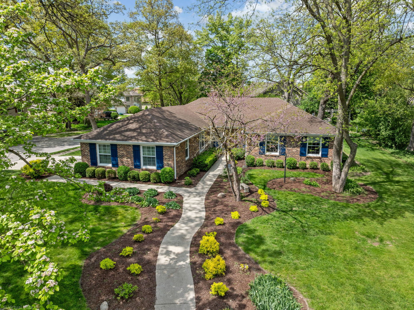 a front view of a house with a yard table and chairs