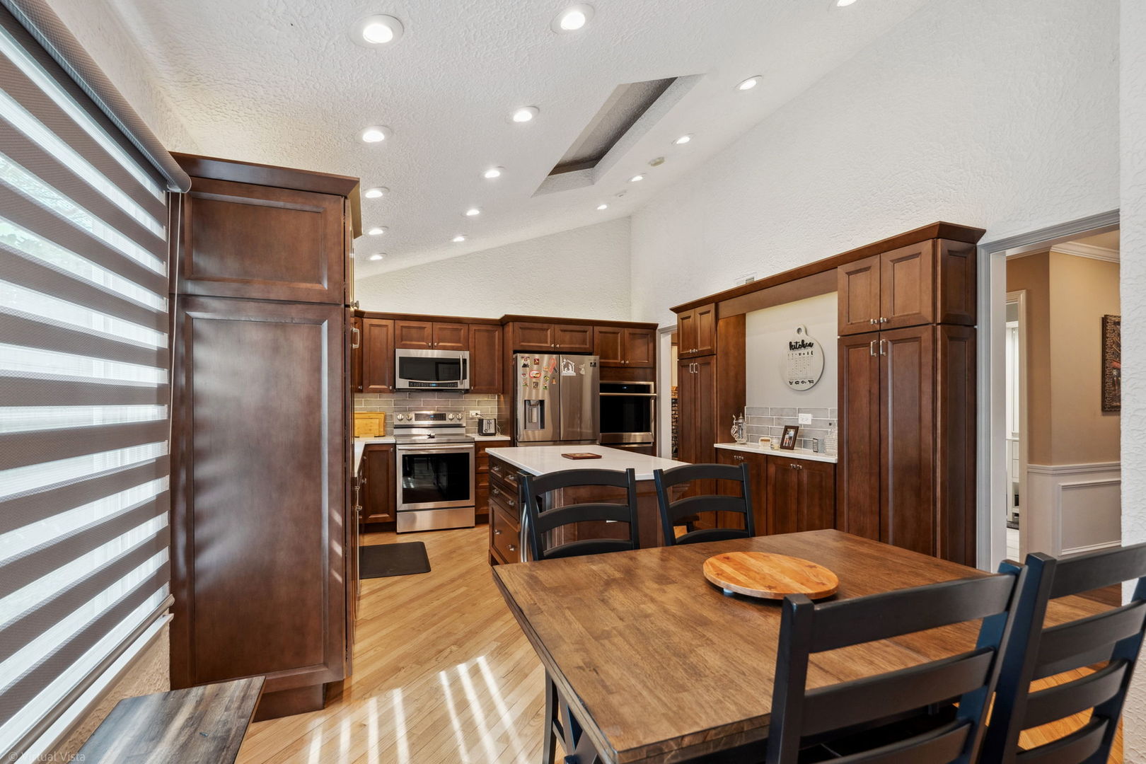 396 Jervey Lane Bartlett, IL 60103 - Photo 16 of 39 a kitchen with sink refrigerator dining table and chairs