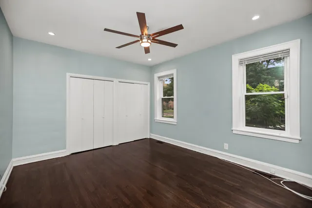 a view of a livingroom with a ceiling fan and wooden floor