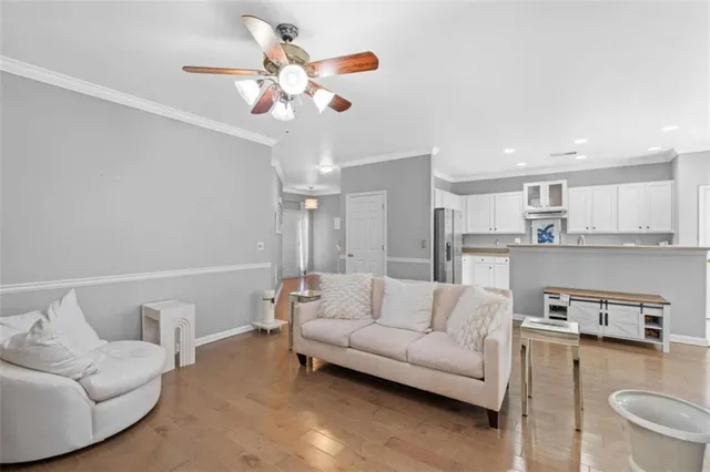a living room with furniture and kitchen view