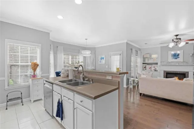 a view of living room kitchen with stainless steel appliances granite countertop furniture and a fireplace