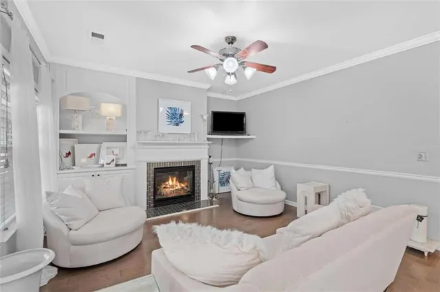 a living room with furniture a fireplace and a flat screen tv