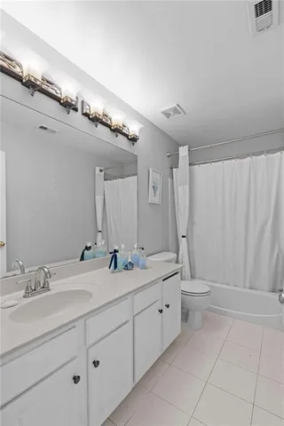 a bathroom with a double vanity sink mirror and toilet