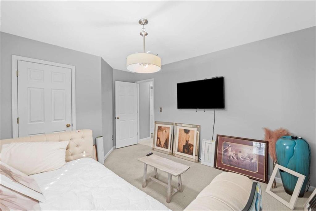 7200 Suttles Drive Southwest South Fulton, GA 30331 - Photo 33 of 44 a living room with furniture and a flat screen tv