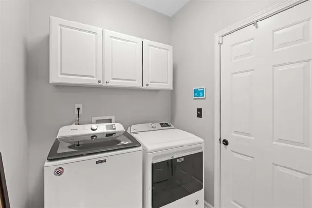 a view of a patio with table and chairs with wooden fence