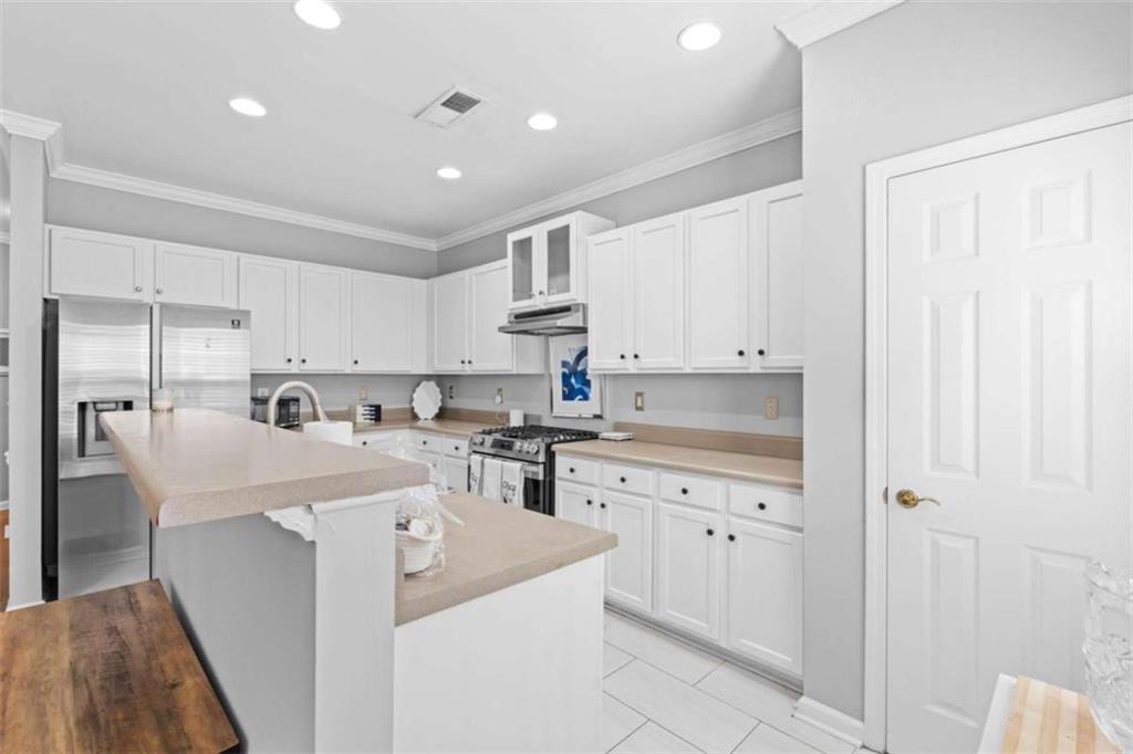 7200 Suttles Drive Southwest South Fulton, GA 30331 - Photo 4 of 44 a kitchen with white cabinets and sink