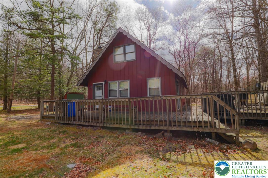 170 Fern Ridge Road Blakeslee, PA 18610 - Photo 1 of 17 a view of a house with wooden fence next to a road