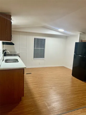 a room with wooden floor and black white walls